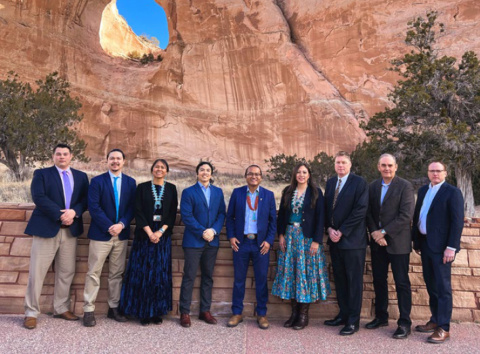 A group photo of politicians by the Window Rock formation in Arizona.