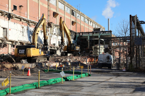 Demolition site with a demolished building and heavy machinery