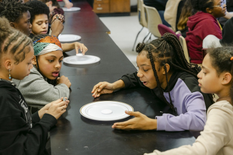 A group of middle school students participating in engineering science experiments