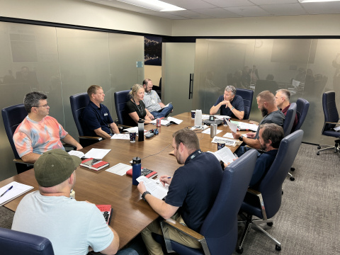 A group of professionals sitting around a conference table having a meeting