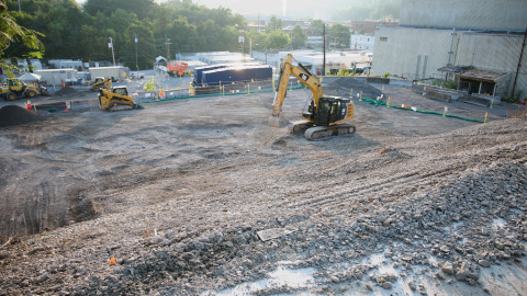 A construction vehicle on a dirt covered demolition site