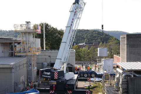 A crane loading a shipment onto a large truck