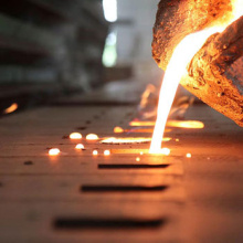 Molten metal being poured into moulds