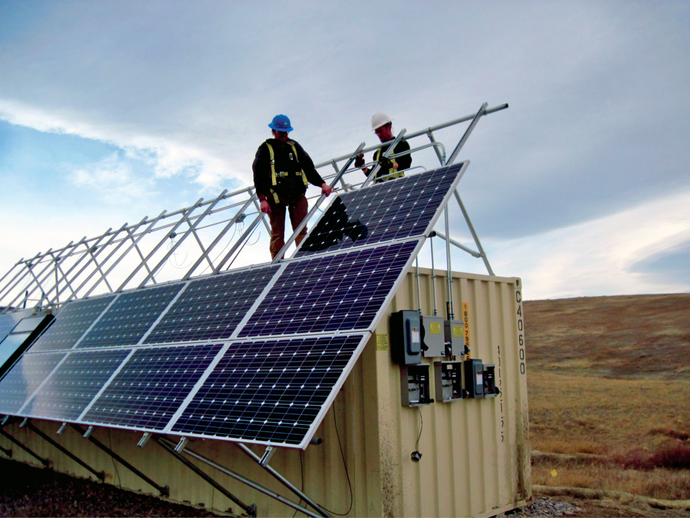 Subcontractor personnel install solar panels and other infrastructure on a 40-foot conex box that houses the batteries and control equipment for the 6 kilowatt photovoltaic system that powers the ETPTS groundwater treatment system.