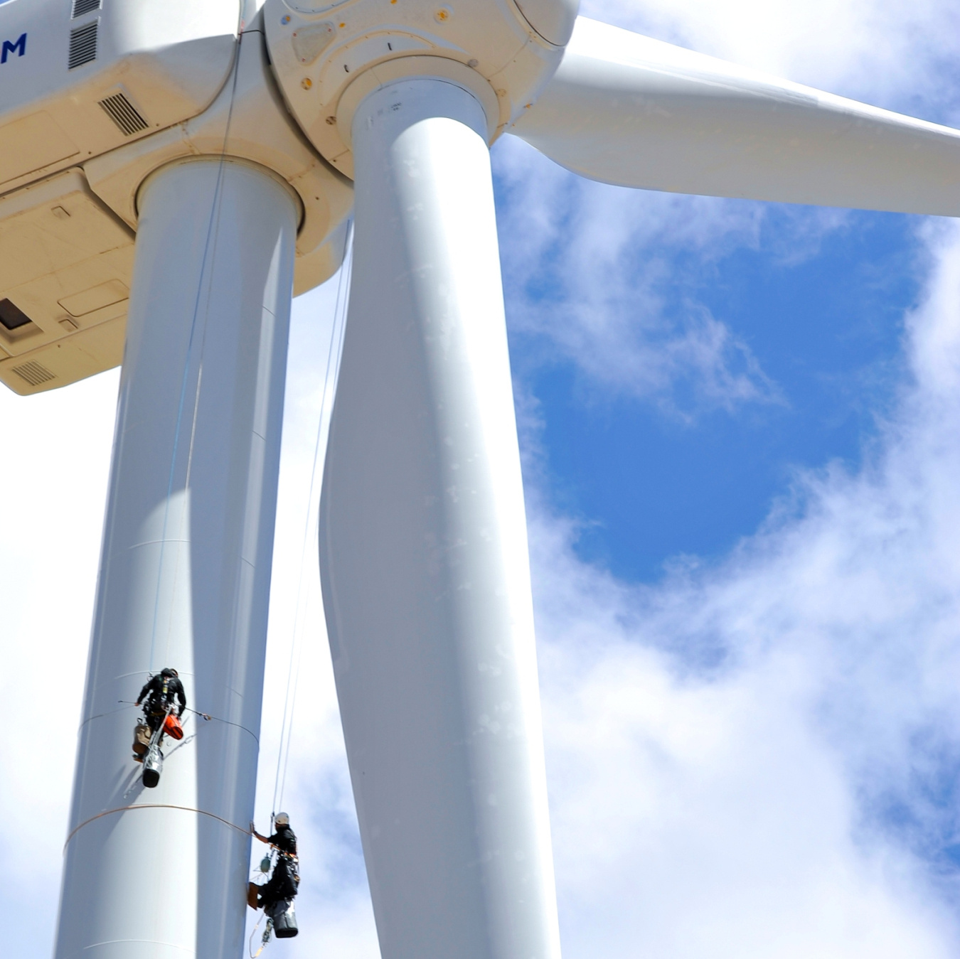 A worker climbing a wind tower.
