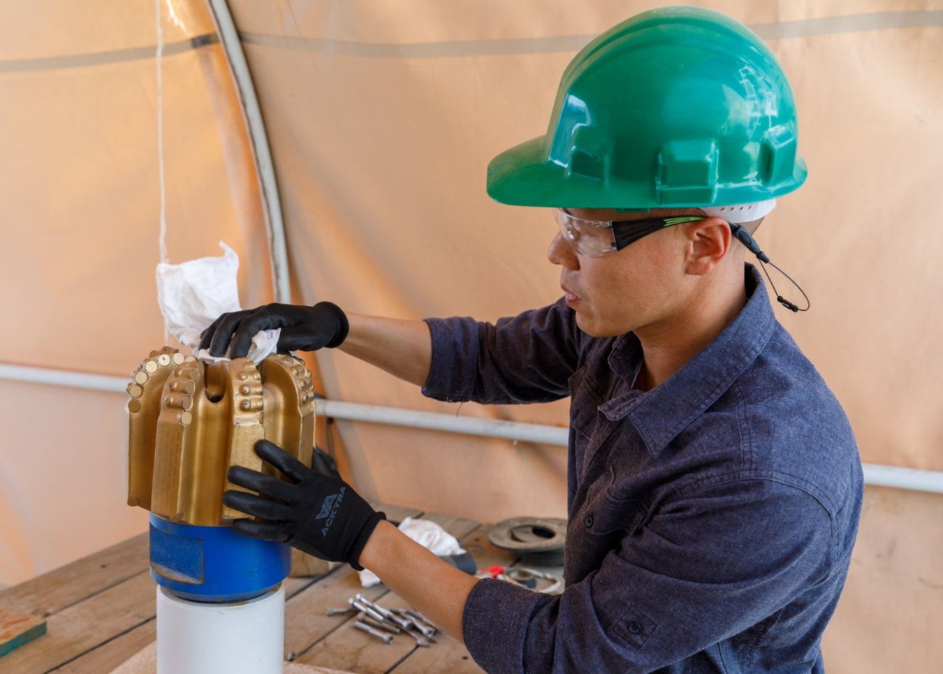 Sandia staff member works with a PDC drill bit