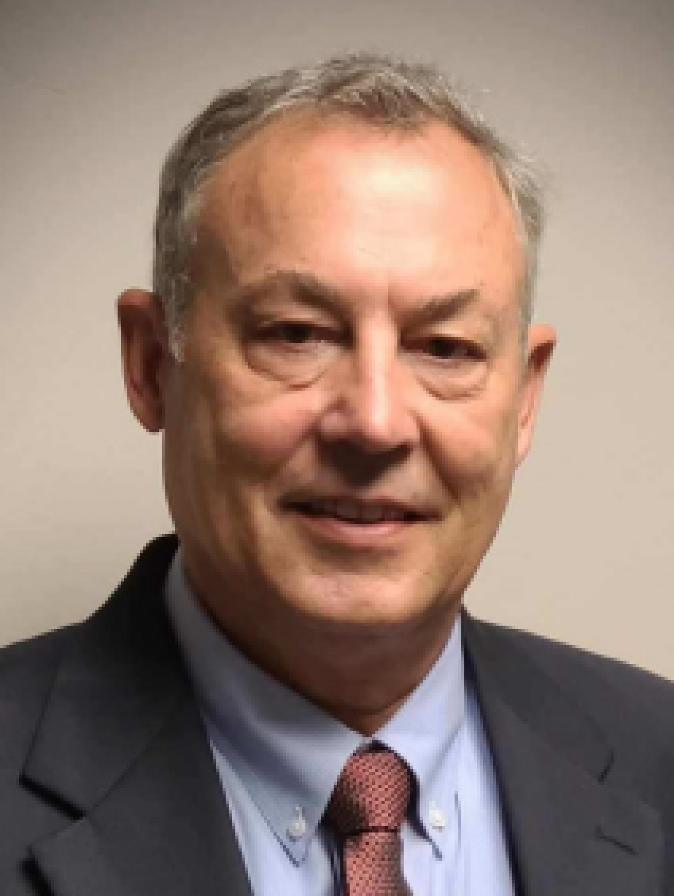 Professional headshot of a man in a suit