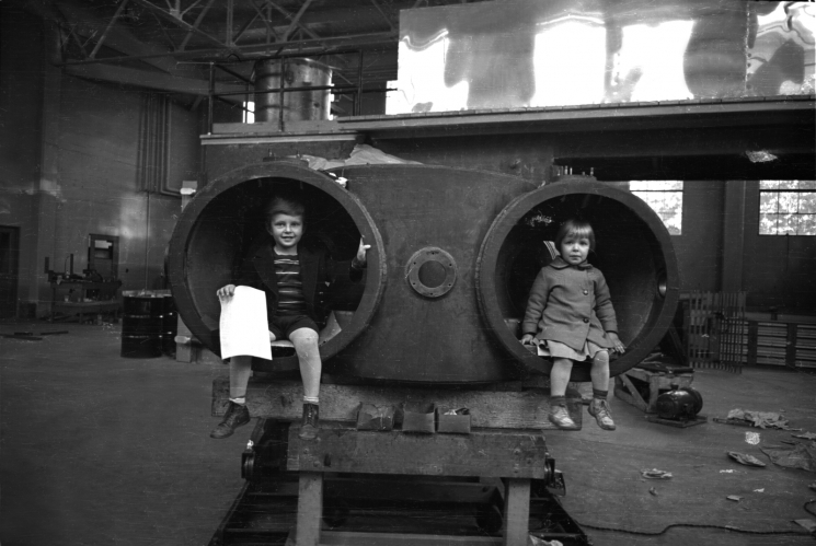 In this 1939 photo, Eric and Margaret Lawrence are sitting inside the tank of something called the 60-inch cyclotron -- a machine invented by their father, Ernest Lawrence. The cyclotron is a unique circular particle accelerator, which Lawrence himself referred to as a "proton merry-go-round." In reality, the cyclotron specialized in smashing atoms. Fun facts: this cyclotron contains a magnet that weighs 220 tons, and experiments conducted on this very machine led to the discovery of plutonium and Nobel Prizes for researchers Glenn Seaborg and Melvin Calvin. Ernest Lawrence passed away in 1958 -- just 23 days later, the Regents of the University of California voted to rename two of the university's nuclear research sites: Lawrence Livermore and Lawrence Berkeley Laboratories. | Photo courtesy of Lawrence Berkeley National Laboratory. In this 1939 photo, Eric and Margaret Lawrence are sitting inside the tank of something called the 60-inch cyclotron -- a machine invented by their father, Ernest Lawrence. The cyclotron is a unique circular particle accelerator, which Lawrence himself referred to as a "proton merry-go-round." In reality, the cyclotron specialized in smashing atoms. Fun facts: this cyclotron contains a magnet that weighs 220 tons, and experiments conducted on this very machine led to the discovery of plutonium and Nobel Prizes for researchers Glenn Seaborg and Melvin Calvin. Ernest Lawrence passed away in 1958 -- just 23 days later, the Regents of the University of California voted to rename two of the university's nuclear research sites: Lawrence Livermore and Lawrence Berkeley Laboratories. | Photo courtesy of Lawrence Berkeley National Laboratory.