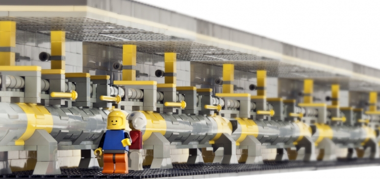 At two miles long, SLAC's linear particle accelerator is a monster of a machine. But now, thanks to an old collection of Legos and some creative work by SLAC graphic designer Greg Stewart, the two-mile accelerator has been drastically reduced in size. After happening upon his Legos at home one night, Stewart decided to spend his evening designing, building and photographing this Lego diorama homage to the inside of the SLAC linac, a place that's 20 feet underground and not often seen by anyone besides the accelerator engineers who work there. SLAC's safety officers will even be pleased to see the Lego workers wearing their "PPE" (personal protective equipment, in this case helmets). See an actual <a href="http://www.flickr.com/photos/slaclab/8282691008/" target="_blank">photo of the SLAC linac</a>. | Photo courtesy of Greg Stewart, SLAC National Accelerator Laboratory. At two miles long, SLAC's linear particle accelerator is a monster of a machine. But now, thanks to an old collection of Legos and some creative work by SLAC graphic designer Greg Stewart, the two-mile accelerator has been drastically reduced in size. After happening upon his Legos at home one night, Stewart decided to spend his evening designing, building and photographing this Lego diorama homage to the inside of the SLAC linac, a place that's 20 feet underground and not often seen by anyone besides the accelerator engineers who work there. SLAC's safety officers will even be pleased to see the Lego workers wearing their "PPE" (personal protective equipment, in this case helmets). See an actual <a href="http://www.flickr.com/photos/slaclab/8282691008/" target="_blank">photo of the SLAC linac</a>. | Photo courtesy of Greg Stewart, SLAC National Accelerator Laboratory.