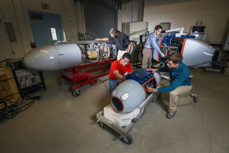 At Sandia National Laboratories, researchers have developed pods that can survey and "taste" radioactive particles without exposing a human crew to nuclear hazards. The three pods, when attached to aerial vehicles, can collect and analyze airborne radioactive particles to track and source gases that can identify a nuclear bomb’s origins. Learn more about the <a href="http://share.sandia.gov/news/resources/news_releases/airborne_pods/" target="_blank">particulate-collection system</a>. | Photo courtesy of Randy Montoya/Sandia National Laboratories. At Sandia National Laboratories, researchers have developed pods that can survey and "taste" radioactive particles without exposing a human crew to nuclear hazards. The three pods, when attached to aerial vehicles, can collect and analyze airborne radioactive particles to track and source gases that can identify a nuclear bomb’s origins. Learn more about the <a href="http://share.sandia.gov/news/resources/news_releases/airborne_pods/" target="_blank">particulate-collection system</a>. | Photo courtesy of Randy Montoya/Sandia National Laboratories.