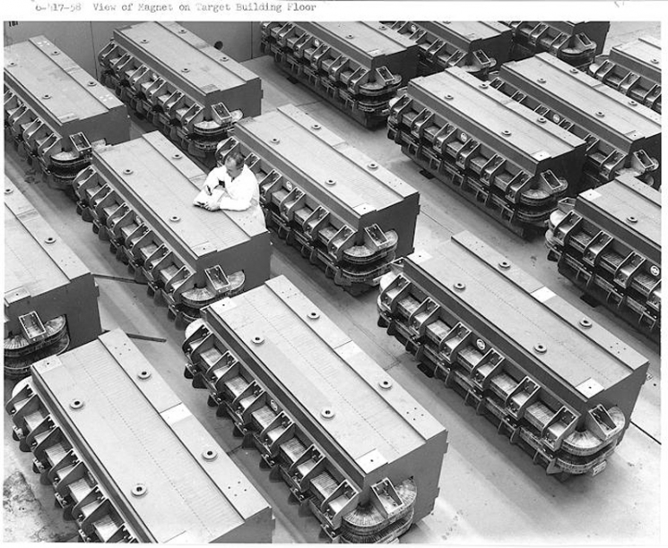 Since 1960, the Alternating Gradient Synchrotron (AGS) has been one of the world's premiere particle accelerators, well known for the <a href="http://www.bnl.gov/bnlweb/history/nobel/" target="_blank">three Nobel Prizes</a> won as a result of research performed there. The AGS name is derived from the concept of alternating gradient focusing, in which the field gradients of the accelerator's 240 magnets are successively alternated inward and outward, permitting particles to be propelled and focused in both the horizontal and vertical plane at the same time. In this 1958 photo, giant magnets await installation into the AGS accelerator ring tunnel at Brookhaven National Laboratory. | Photo courtesy of Brookhaven National Laboratory. Since 1960, the Alternating Gradient Synchrotron (AGS) has been one of the world's premiere particle accelerators, well known for the <a href="http://www.bnl.gov/bnlweb/history/nobel/" target="_blank">three Nobel Prizes</a> won as a result of research performed there. The AGS name is derived from the concept of alternating gradient focusing, in which the field gradients of the accelerator's 240 magnets are successively alternated inward and outward, permitting particles to be propelled and focused in both the horizontal and vertical plane at the same time. In this 1958 photo, giant magnets await installation into the AGS accelerator ring tunnel at Brookhaven National Laboratory. | Photo courtesy of Brookhaven National Laboratory.