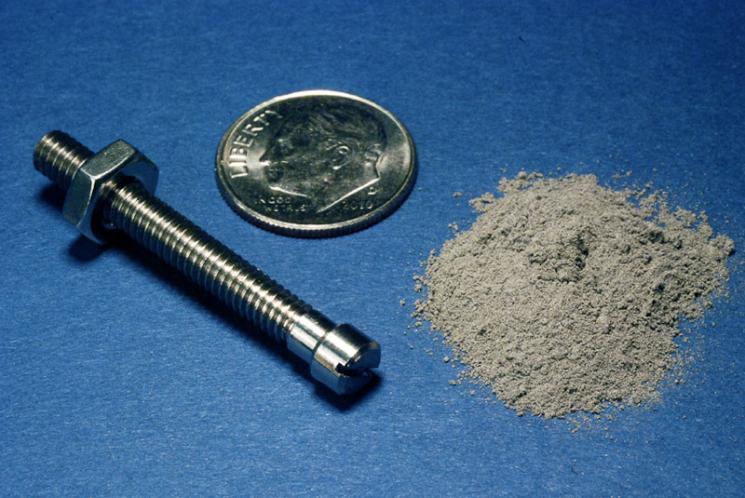 Using gas atomization technology developed at the Ames Lab (click through the photo to see a video), IPAT will be able to make titanium powder 10 times more efficiently than traditional powder-making methods. Above right, 1.8 grams of gas atomized titanium powder makes a finished 1.8 gram titanium bolt. | Image Courtesy of IPAT Using gas atomization technology developed at the Ames Lab (click through the photo to see a video), IPAT will be able to make titanium powder 10 times more efficiently than traditional powder-making methods. Above right, 1.8 grams of gas atomized titanium powder makes a finished 1.8 gram titanium bolt. | Image Courtesy of IPAT