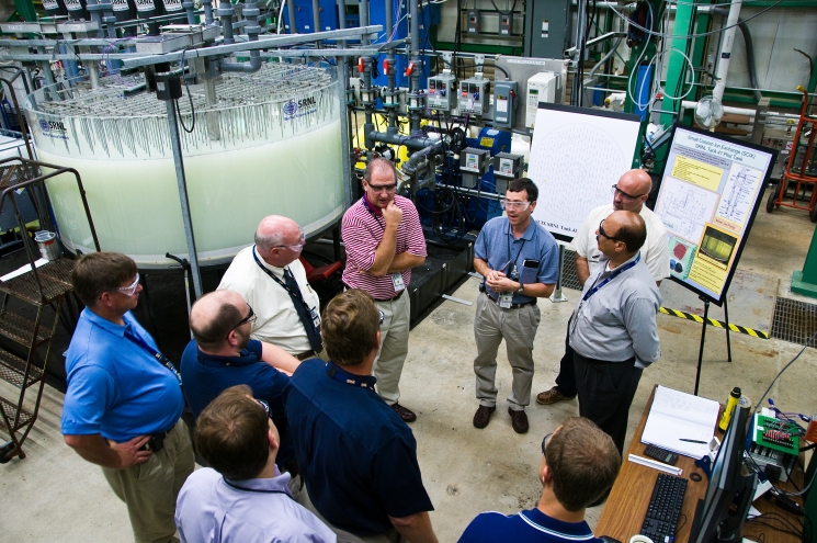 Employees with Savannah River Remediation, the SRS liquid waste contractor, review mock-ups of the SCIX technology at the Savannah River National Laboratory. Employees with Savannah River Remediation, the SRS liquid waste contractor, review mock-ups of the SCIX technology at the Savannah River National Laboratory.