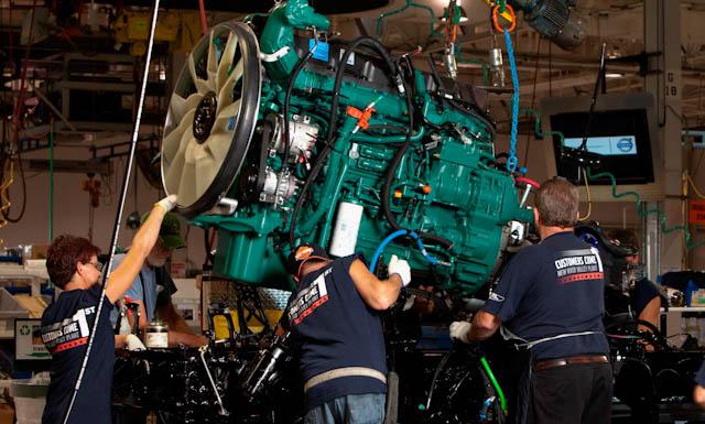 Workers at Volvo Trucks' New River Valley plant guide an engine into place. | Courtesy of Volvo Trucks Workers at Volvo Trucks' New River Valley plant guide an engine into place. | Courtesy of Volvo Trucks