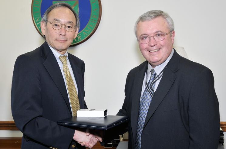 Secretary Chu hands a Secretarial Achievement Awards to Louis Sadler, who negotiating an agreement to allow a private company to construct and operate solar panels at Brookhaven National Laboratory. The solar array supplies electricity for Long Island while helping the lab achieve its sustainability goals. | Energy Department Photo Secretary Chu hands a Secretarial Achievement Awards to Louis Sadler, who negotiating an agreement to allow a private company to construct and operate solar panels at Brookhaven National Laboratory. The solar array supplies electricity for Long Island while helping the lab achieve its sustainability goals. | Energy Department Photo
