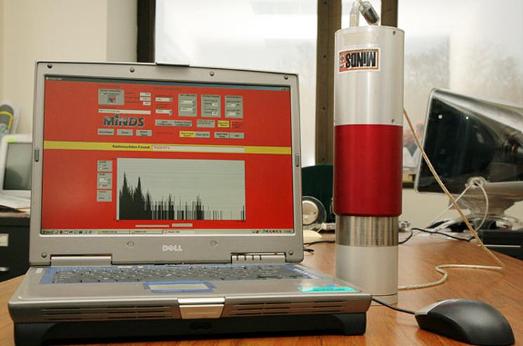 The simple, portable device identifies materials through their characteristic energy signals as unique as fingerprints. The three detectors are housed in a thermos-sized container that is connected to a laptop computer. The device issues a signal turning the laptop display bright red when nuclear material of interest is identified. | Photo courtesy of Princeton University The simple, portable device identifies materials through their characteristic energy signals as unique as fingerprints. The three detectors are housed in a thermos-sized container that is connected to a laptop computer. The device issues a signal turning the laptop display bright red when nuclear material of interest is identified. | Photo courtesy of Princeton University