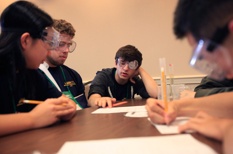 Students at the Cypress Bay High School, Weston, Fla., concentrate on finding the density of an unknown liquid and the mass of an unknown object through an experiment in buoyancy in the first round of the high school division team challenge competition at the U.S. Department of Energy National Science Bowl in Washington DC on April 27, 2012. | Photo by Dennis Brack, Office of Science. Students at the Cypress Bay High School, Weston, Fla., concentrate on finding the density of an unknown liquid and the mass of an unknown object through an experiment in buoyancy in the first round of the high school division team challenge competition at the U.S. Department of Energy National Science Bowl in Washington DC on April 27, 2012. | Photo by Dennis Brack, Office of Science.