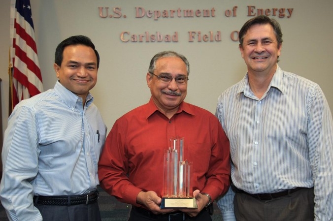 Department of Energy Carlsbad Field Site Operations Director Casey Gadbury (right) and Farok Sharif, President and Project Manager for Nuclear Waste Partnership
LLC, the management and operating contractor at the Waste Isolation Pilot Plant, present the DOE's Voluntary Protection Program Legacy Star Award to Richard De Los Santos, protective force manager for Security Walls, the security contractor at the Waste Isolation Pilot Plant. The DOE-VPP legacy star award is the highest level of recognition possible in the VPP. Department of Energy Carlsbad Field Site Operations Director Casey Gadbury (right) and Farok Sharif, President and Project Manager for Nuclear Waste Partnership
LLC, the management and operating contractor at the Waste Isolation Pilot Plant, present the DOE's Voluntary Protection Program Legacy Star Award to Richard De Los Santos, protective force manager for Security Walls, the security contractor at the Waste Isolation Pilot Plant. The DOE-VPP legacy star award is the highest level of recognition possible in the VPP.