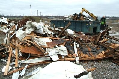 Workers cut up old trailers and placed them in containers so that the debris could be placed in the site’s industrial landfill. Workers cut up old trailers and placed them in containers so that the debris could be placed in the site’s industrial landfill.