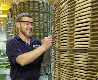 Bob Wilds working at a winding machine. | Photo Courtesy of Waukesha Electric Systems