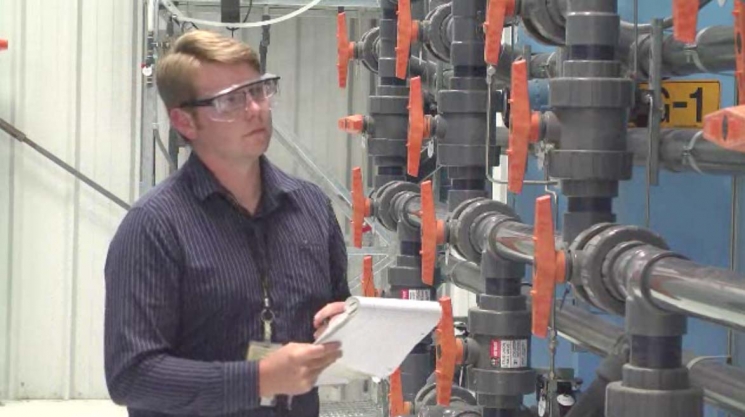 Dean Neshem, a pump-and-treat operations and maintenance engineer, observes operations at one of the Hanford site's five groundwater treatment facilities. Based on
technical recommendations from DOE, CH2M HILL engineers tested and compared multiple resins to determine the products capable of removing contaminants from the groundwater. Dean Neshem, a pump-and-treat operations and maintenance engineer, observes operations at one of the Hanford site's five groundwater treatment facilities. Based on
technical recommendations from DOE, CH2M HILL engineers tested and compared multiple resins to determine the products capable of removing contaminants from the groundwater.