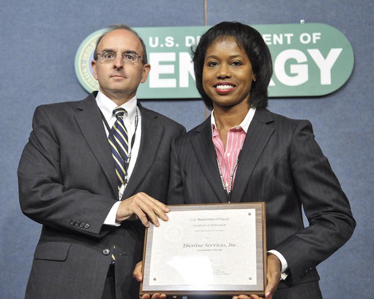 Shelton Clark, President of Eberline Services, receives the Small Business of the Year award from Dot Harris, Director of the Office of Economic Impact and Diversity. Eberline Services, a New Mexico-based small business, gets 90% of their business from the Energy Department. They specialize in radiological protection and environmental services. | Photo by Charles Watkins, DOE Photographer. Shelton Clark, President of Eberline Services, receives the Small Business of the Year award from Dot Harris, Director of the Office of Economic Impact and Diversity. Eberline Services, a New Mexico-based small business, gets 90% of their business from the Energy Department. They specialize in radiological protection and environmental services. | Photo by Charles Watkins, DOE Photographer.