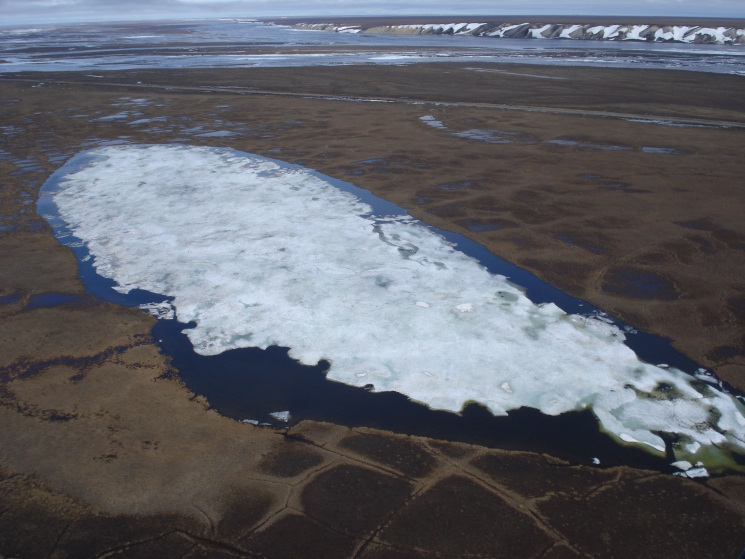 The aerial view shows the experimental lake at Franklin Bluffs used for the snowfence experiment.