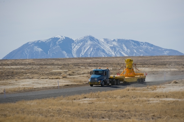 The HFEF-6 cask is transported on the haul road. The HFEF-6 cask is transported on the haul road.
