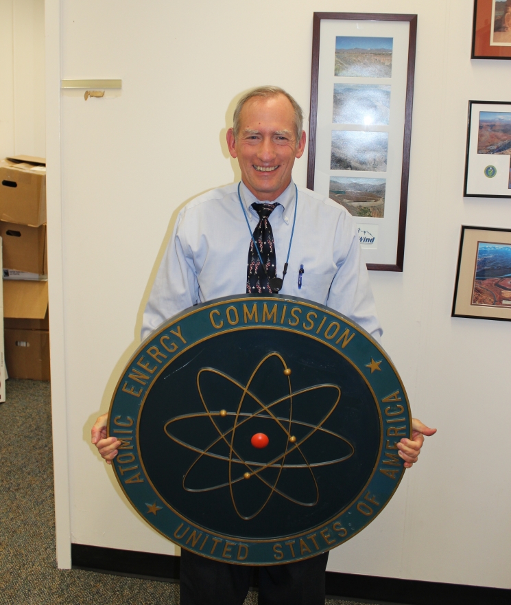 Office of Environmental Management Deputy Assistant Secretary Ken Picha holds an Atomic Energy Commission sign he found in the Forrestal Building. | Photo courtesy of Ken Picha Office of Environmental Management Deputy Assistant Secretary Ken Picha holds an Atomic Energy Commission sign he found in the Forrestal Building. | Photo courtesy of Ken Picha