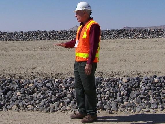 Moab Federal Project Director Donald Metzler stands on a final cover layer of the disposal cell. Several other layers are visible behind him. Moab Federal Project Director Donald Metzler stands on a final cover layer of the disposal cell. Several other layers are visible behind him.