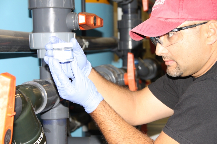 An operator tests the resin at a 100K Area pump-andtreat system to determine how much hexavelent chromium contamination it has gathered from the groundwater. An operator tests the resin at a 100K Area pump-andtreat system to determine how much hexavelent chromium contamination it has gathered from the groundwater.
