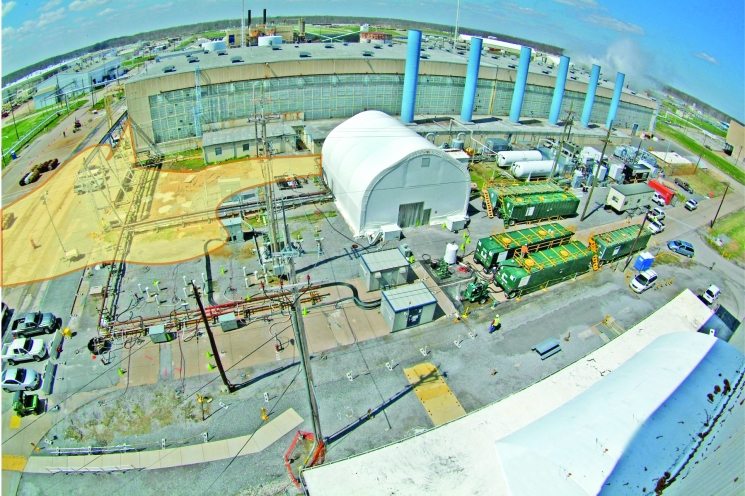 The yellow outline depicts an area southeast of the C-400 Cleaning Building, background, where electrical resistance heating will be used to remove trichloroethene (TCE) down to 60 feet below ground. Electrodes will heat the chemical into a vapor that can be pumped to the surface and treated in the white structure, center. The yellow outline depicts an area southeast of the C-400 Cleaning Building, background, where electrical resistance heating will be used to remove trichloroethene (TCE) down to 60 feet below ground. Electrodes will heat the chemical into a vapor that can be pumped to the surface and treated in the white structure, center.