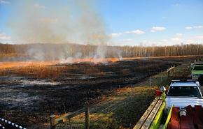 Firefighters keep watch as the controlled prairie burn is completed at the Portsmouth Site. Firefighters keep watch as the controlled prairie burn is completed at the Portsmouth Site.
