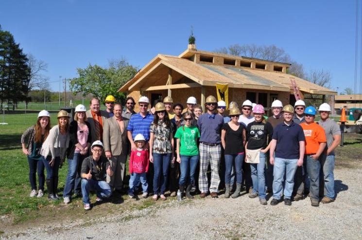 Purdue's INhome team at their recent "Topping Out" party (note the little tree on the roof of the house). | Photo Courtesy of the Purdue INhome Solar Decathlon team