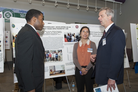 South Carolina State University students William Dumpson, left, and Alejandra Chirino, center, talk with Savannah River National Laboratory Director Dr. Terry Michalske at a recent research exchange involving the laboratory and seven historically black colleges and universities.