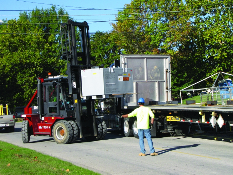 Workers load boxes containing contaminated soil that surrounded Tank W-1A. Workers load boxes containing contaminated soil that surrounded Tank W-1A.