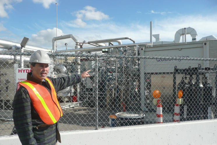 Professor Jack Brouwer, Associate Director and Chief Technology Officer of the National Fuel Cell Research Center, points out the tri-generation facility that uses biogas from Orange County Sanitation District’s wastewater treatment plant to produce hydrogen, heat and power. | Photo courtesy of the Energy Department. Professor Jack Brouwer, Associate Director and Chief Technology Officer of the National Fuel Cell Research Center, points out the tri-generation facility that uses biogas from Orange County Sanitation District’s wastewater treatment plant to produce hydrogen, heat and power. | Photo courtesy of the Energy Department.