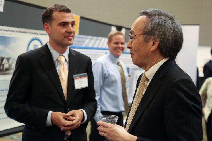 William Parish from Solar Mosaic, one of nine solar startups chosen for the latest round of SunShot Incubator funding, discusses his company’s project with Energy Secretary Steven Chu at the SunShot Grand Challenge Summit in Denver, Colorado. | Photo by John De La Rosa. William Parish from Solar Mosaic, one of nine solar startups chosen for the latest round of SunShot Incubator funding, discusses his company’s project with Energy Secretary Steven Chu at the SunShot Grand Challenge Summit in Denver, Colorado. | Photo by John De La Rosa.
