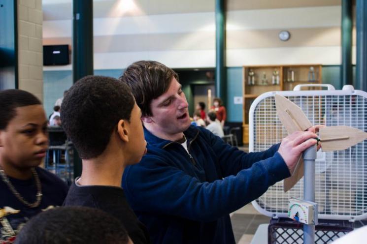 JMU student Greg Miller shows Northumberland students how the blades of a wind turbine work | courtesy of Virginia Center for Wind Energy