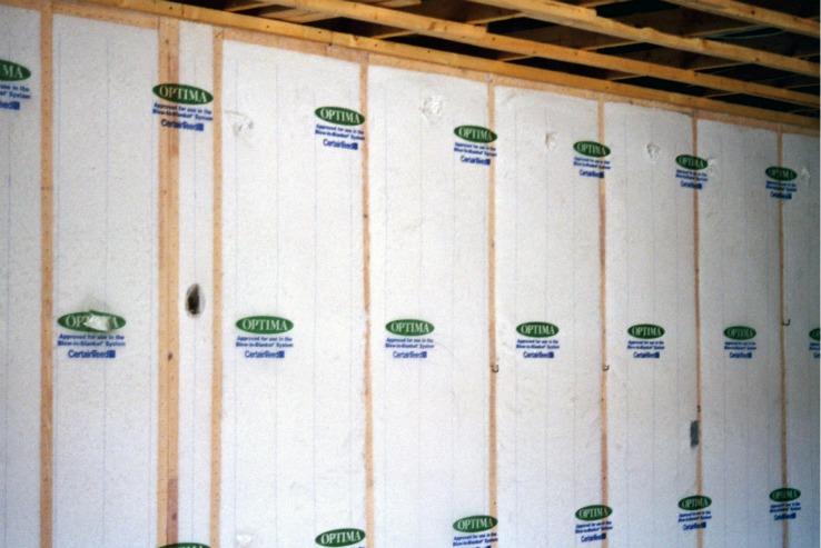 Blown-in fiberglass insulation thoroughly fills the stud cavities in this home. | Photo courtesy of Bob Hendron, NREL. Blown-in fiberglass insulation thoroughly fills the stud cavities in this home. | Photo courtesy of Bob Hendron, NREL.