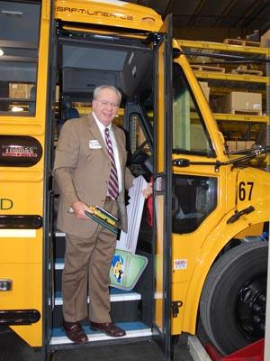 Ed McNeel, superintendent of Corbin's school district, poses aboard the district's new hybrid-diesel bus. | Photo Courtesy of Susie Hart. Ed McNeel, superintendent of Corbin's school district, poses aboard the district's new hybrid-diesel bus. | Photo Courtesy of Susie Hart.