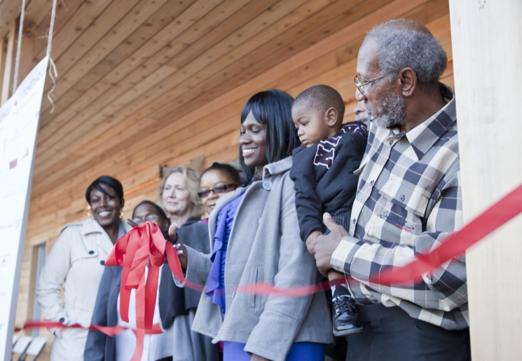 One of the new homeowners, Layika Culley, and her family cut the ribbon to her new ultra-efficient home in the historic Deanwood neighborhood. For more photos of the Empowerhouse ribbon cutting, <a href="/node/580963">view our photo gallery</a>. | Photo courtesy of Sarah Gerrity, Energy Department. One of the new homeowners, Layika Culley, and her family cut the ribbon to her new ultra-efficient home in the historic Deanwood neighborhood. For more photos of the Empowerhouse ribbon cutting, <a href="/node/580963">view our photo gallery</a>. | Photo courtesy of Sarah Gerrity, Energy Department.