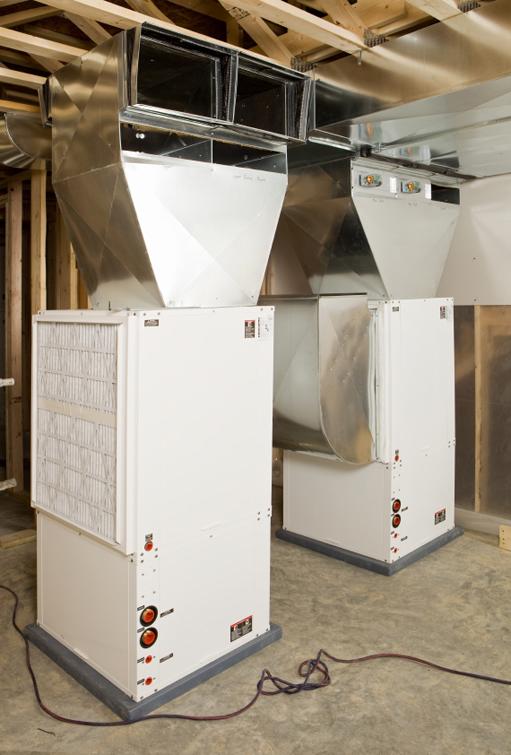 These geothermal heating and cooling units installed in the basement of a new home are tied to a complex array of underground coils to keep indoor temperatures comfortable. | Photo courtesy of ©iStockphoto/BanksPhotos
