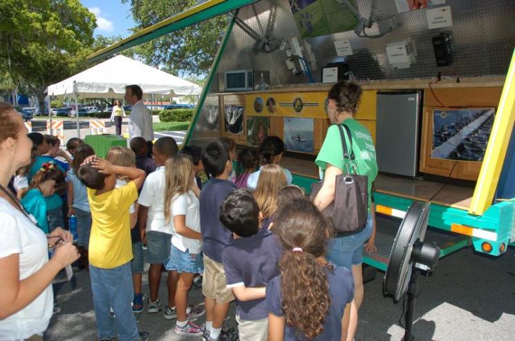 Elementary school students look over a solar demonstration trailer. | Photo courtesy of the City of Hollywood, FL