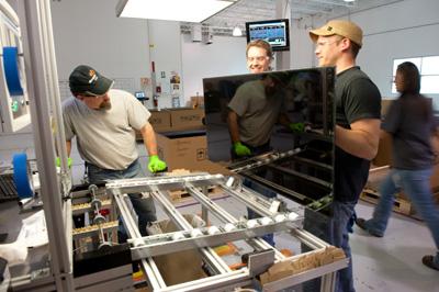 Workers at Abound Solar -- who are about to get more than 1,000 new colleagues -- make a thin-film solar panel. | Photo courtesy of Abound Solar Workers at Abound Solar -- who are about to get more than 1,000 new colleagues -- make a thin-film solar panel. | Photo courtesy of Abound Solar