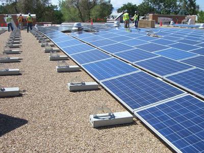 Workers install a solar photovoltaic system on the roof of a Denver school.| Photo courtesy of Main Street Power Workers install a solar photovoltaic system on the roof of a Denver school.| Photo courtesy of Main Street Power