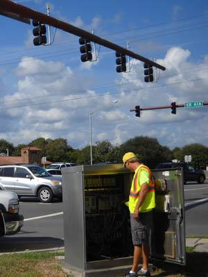 A worker synchronizes a traffic light on State Road A1A in St. Augustine, FL. | Energy Department Photo |