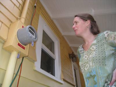 Laura Smoyer checks the net-metering device in her home, which now uses the sun for about 38 percent of its total energy use. | Department of Energy Photo | Laura Smoyer checks the net-metering device in her home, which now uses the sun for about 38 percent of its total energy use. | Department of Energy Photo |