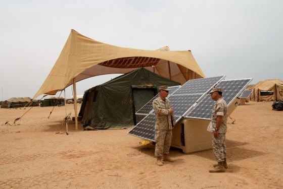 Maj. Sean M. Sadlier (left) of the U.S. Marine Corps Expeditionary Energy Office explains the solar power element of the Expeditionary Forward Operating Base concept to Col. Anthony Fernandez during the testing phase of this sustainable energy initiative. | Photo Courtesy of U.S. Marine Corps | Photo by Maj. Paul Greenberg |
Maj. Sean M. Sadlier (left) of the U.S. Marine Corps Expeditionary Energy Office explains the solar power element of the Expeditionary Forward Operating Base concept to Col. Anthony Fernandez during the testing phase of this sustainable energy initiative. | Photo Courtesy of U.S. Marine Corps | Photo by Maj. Paul Greenberg |