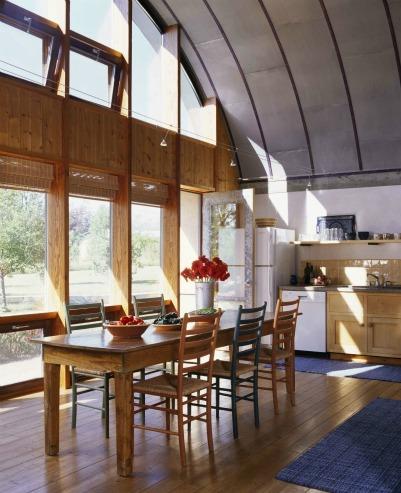 Energy-efficient windows provide space heating and lighting to this sunny kitchen. | Photo courtesy of Emily Minton-Redfield for Jim Logan Architects.
